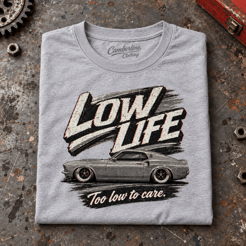 Low Life Monochrome Muscle Car Stance Graphic T-Shirt — Sport Grey, folded front main hero on a worn automotive workbench – car-ts-0075