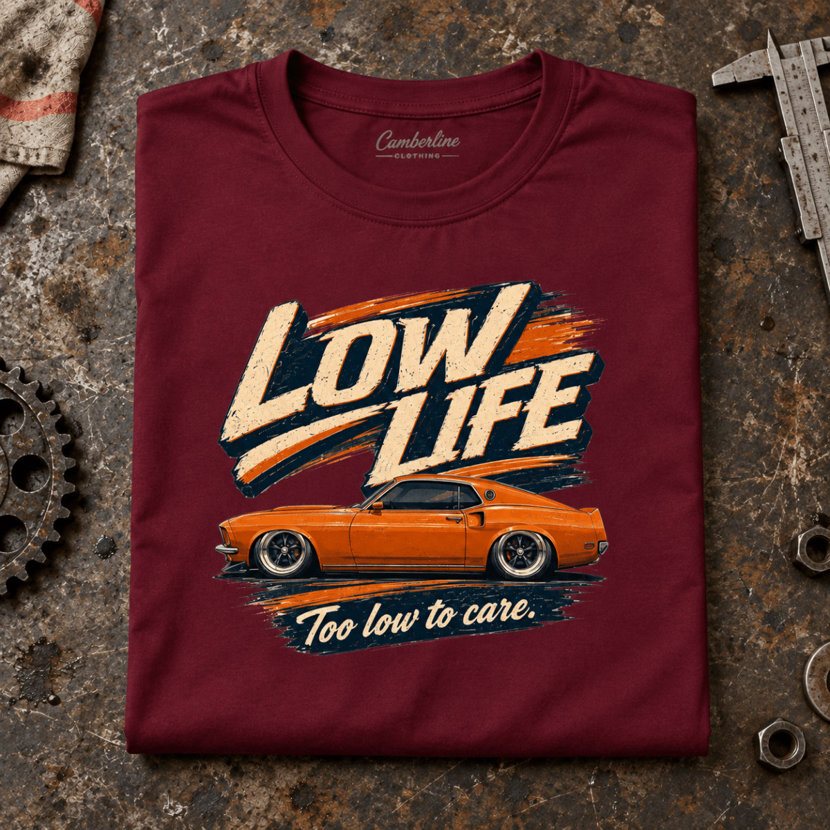 Muscle Car Graphic T-Shirt – Low Life V8 Custom, folded front main hero on a worn automotive workbench – car-ts-0074
