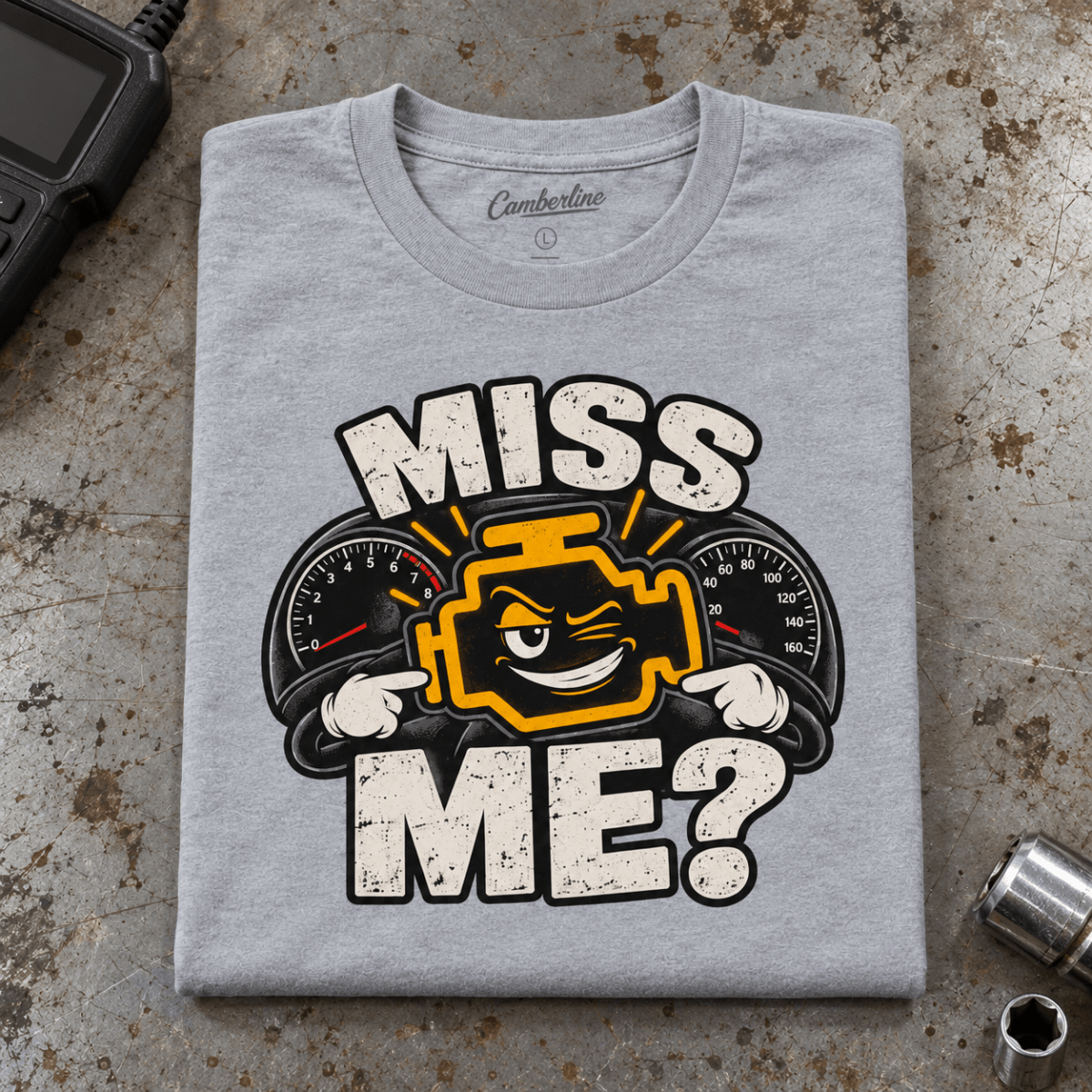Camberline Check Engine Mechanic T-Shirt in heather grey, folded front view on a workshop bench with full graphic visible