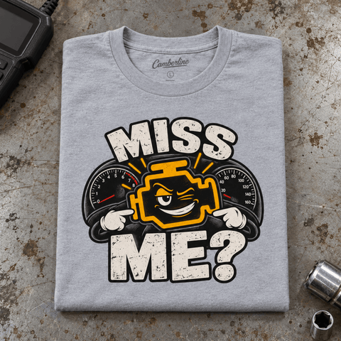 Camberline Check Engine Mechanic T-Shirt in heather grey, folded front view on a workshop bench with full graphic visible