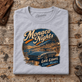 Classic Coupe Graphic T-Shirt – Monaco Nights, folded front main hero on a worn automotive workbench – car-ts-0054