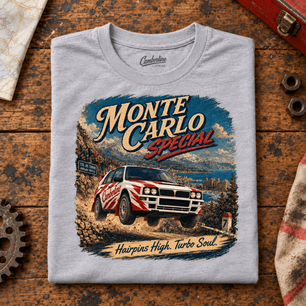 Rally Car Graphic T-Shirt – Monte Carlo Special Turbo Soul Hairpins, folded front main hero on a worn automotive workbench – car-ts-0044