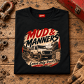 Camberline mud and manners 4x4 black T-shirt, folded front view on a workshop bench with the complete graphic visible.