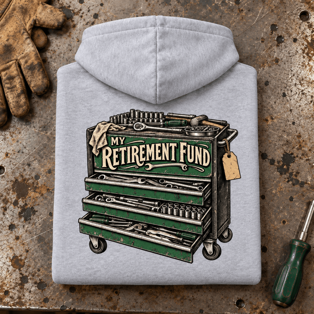 Camberline Tool Chest Mechanic Hoodie in heather grey, folded back view on a workshop bench with full graphic visible