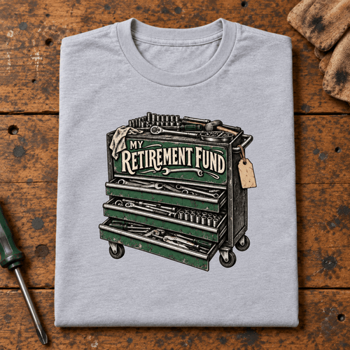 Camberline Tool Chest Mechanic T-Shirt in heather grey, folded front view on a workshop bench with full graphic visible