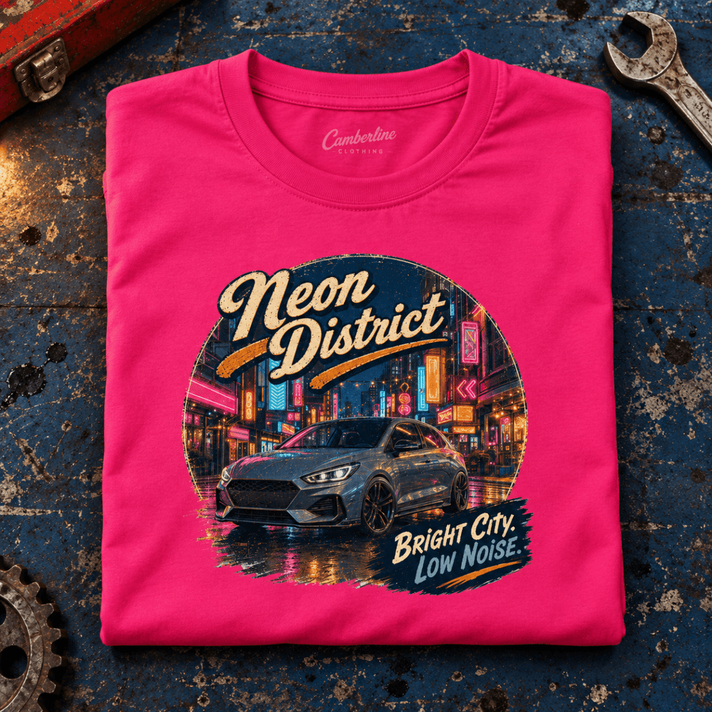 Hot Hatch Graphic T-Shirt – Neon District Urban Night Drive, folded front main hero on a worn automotive workbench – car-ts-0058