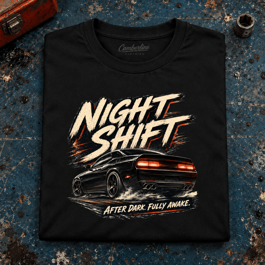 Muscle Car Graphic T-Shirt – Night Shift V8 Night Drive, folded front main hero on a worn automotive workbench – car-ts-0073