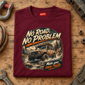 Folded maroon No Road No Problem Adventure T-shirt front on a workshop bench — car-ts-0090