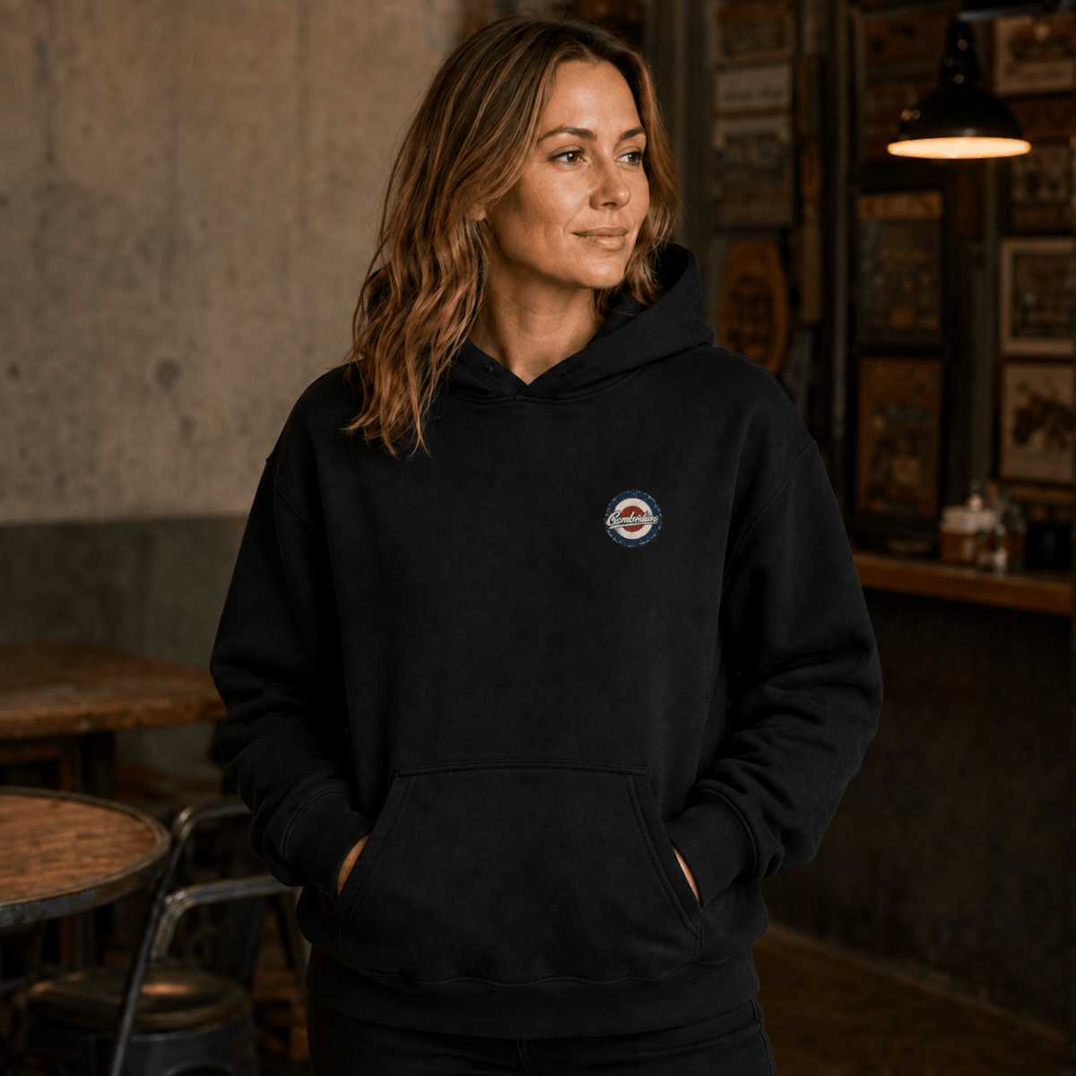 Front view of model wearing the black Camberline hoodie with left-chest print