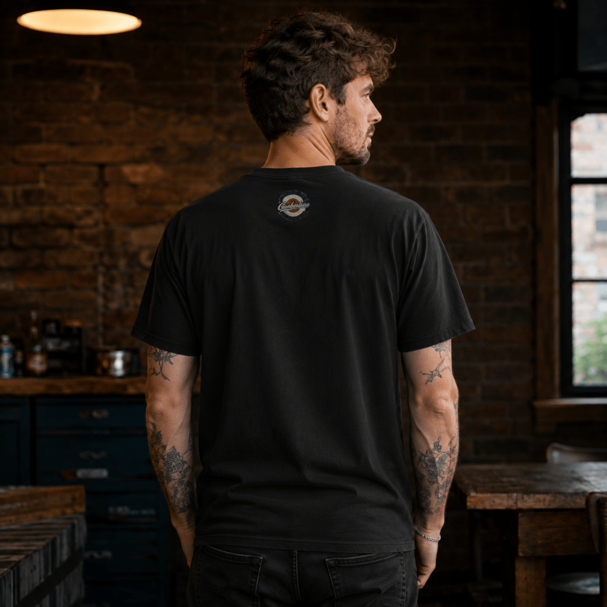 Back view of model wearing the black Camberline T-shirt with nape print