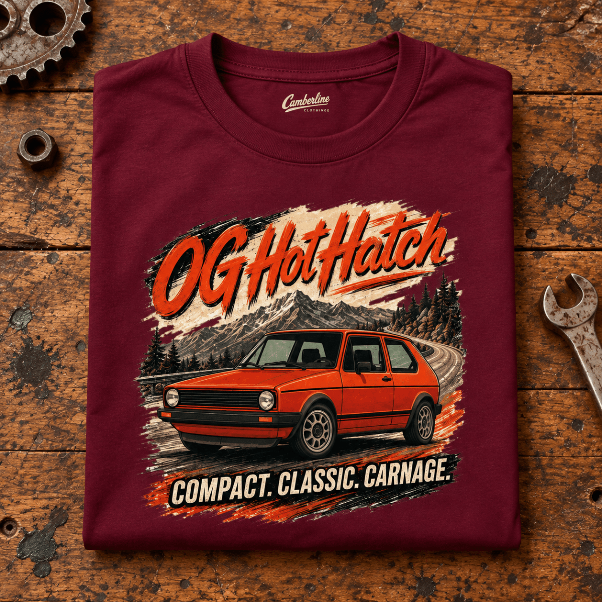 Hot Hatch Graphic T-Shirt – OG Classic Hatchback Pioneer, folded front main hero on a worn automotive workbench – car-ts-0011