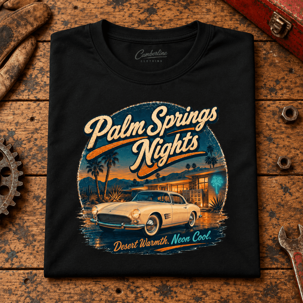 Classic Roadster Graphic T-Shirt – Palm Springs Nights Classic Desert Drive, folded front main hero on a worn automotive workbench – car-ts-0060