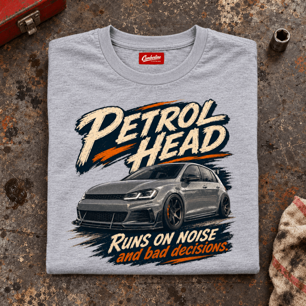 Hot Hatch Graphic T-Shirt – Performance Car Enthusiast, folded front main hero on a worn automotive workbench – car-ts-0083