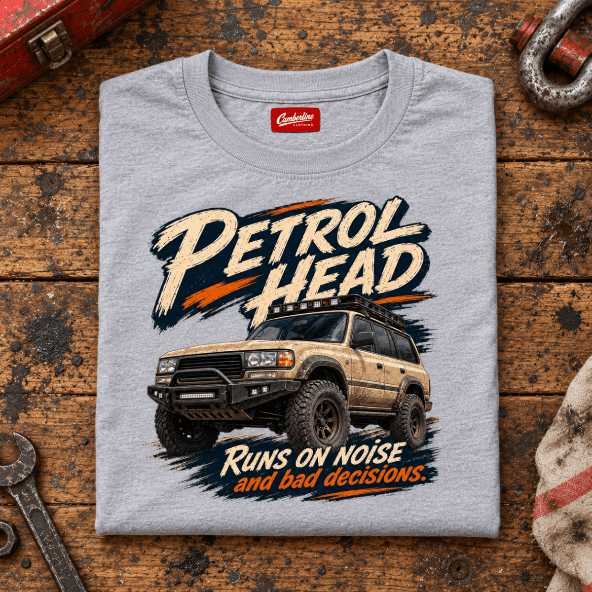 4x4 Off Road Graphic T-Shirt – Petrol Head, folded front hero on a worn automotive workbench – car-ts-0078
