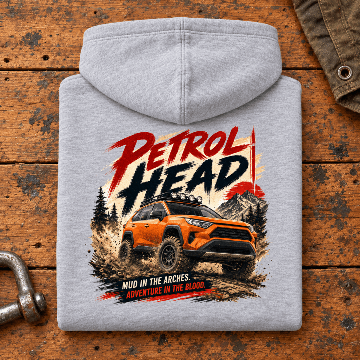 Folded heather grey Petrol Head Orange SUV hoodie back on a workshop bench — car-hd-0007