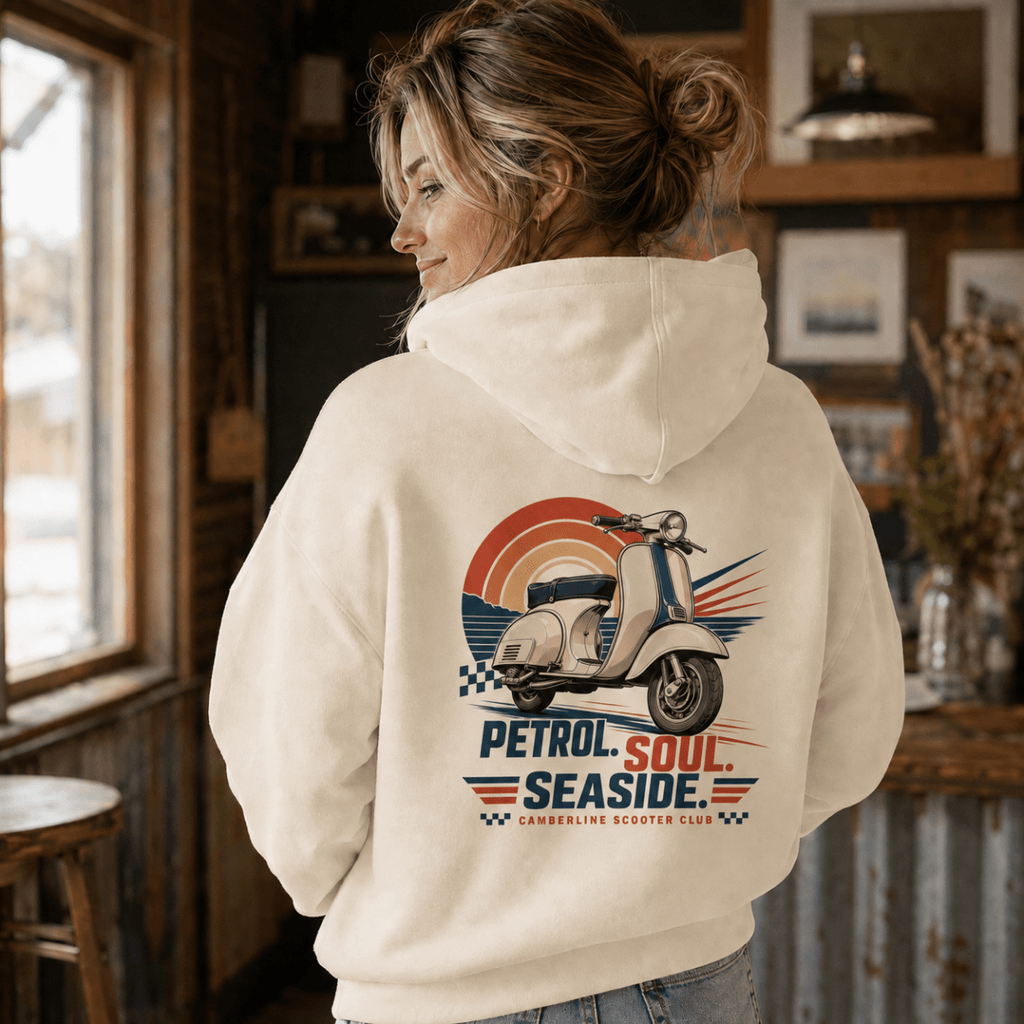 Model wearing a cream Petrol Soul Seaside vintage scooter graphic hoodie, back print view
