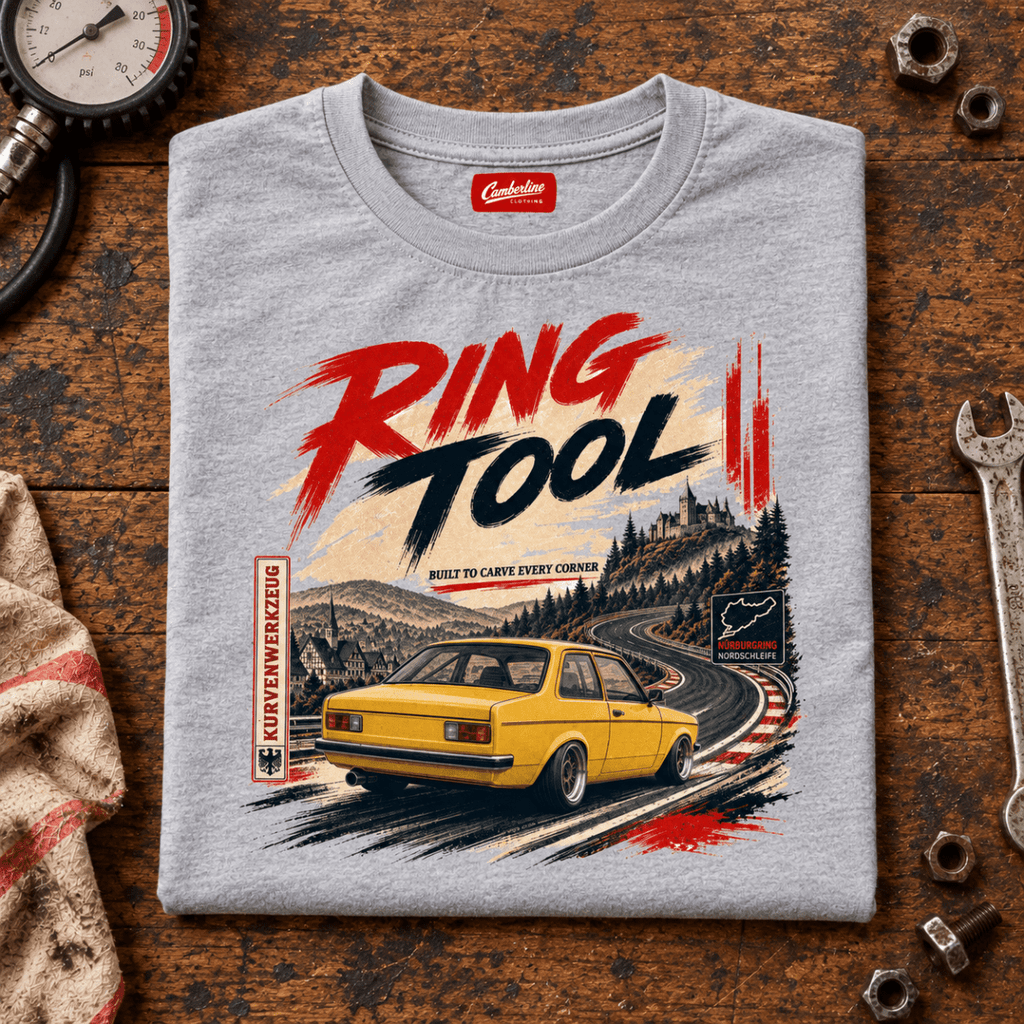 Folded sport grey Ring Tool yellow track car T-shirt, front print on a worn workshop bench — car-ts-0045