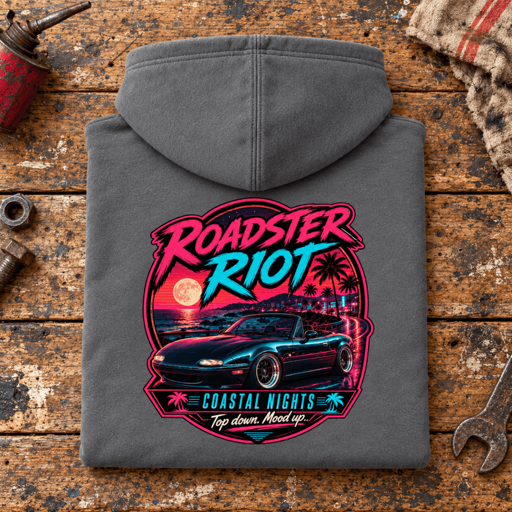 Classic Roadster Graphic Hoodie – Riot Coastal Nights Top Down, folded back main hero on a worn automotive workbench – car-hd-0047