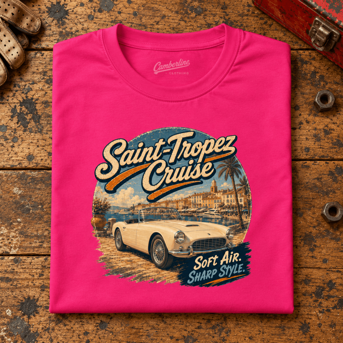Classic Roadster Graphic T-Shirt – Saint Tropez Cruise Classic Riviera, folded front main hero on a worn automotive workbench – car-ts-0051