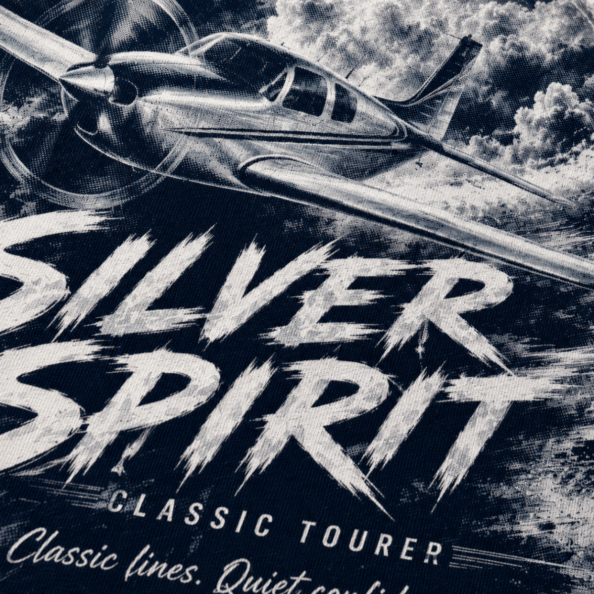 Close-up of Silver Spirit light aircraft halftone DTF print on navy fabric