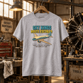 Sport grey Sky Kings Route Escobar twin-engine aircraft graphic T-shirt in a gritty aviation workshop