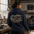 Model wearing Sky Raider navy aviation hoodie with fighter aircraft back print