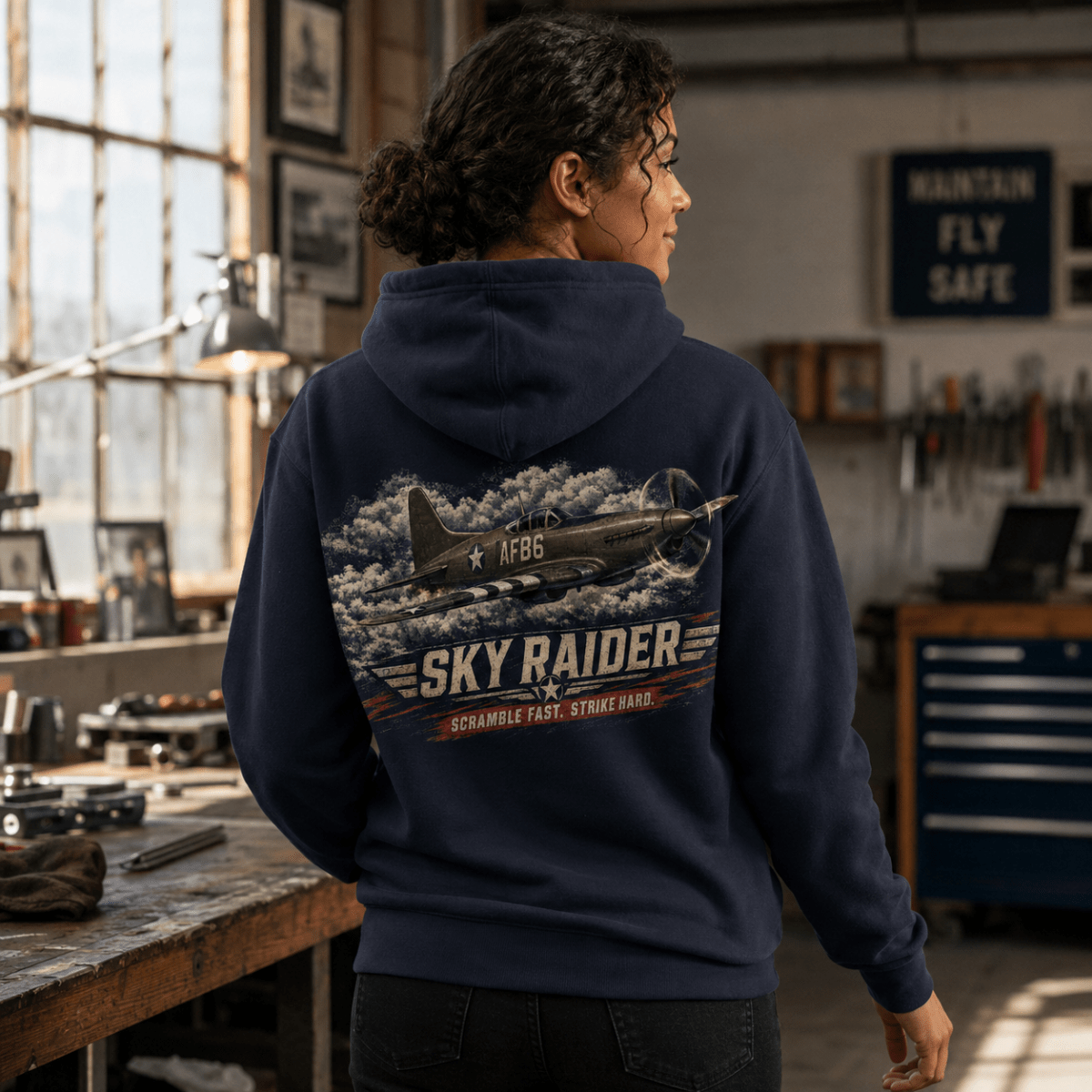 Model wearing Sky Raider navy aviation hoodie with fighter aircraft back print