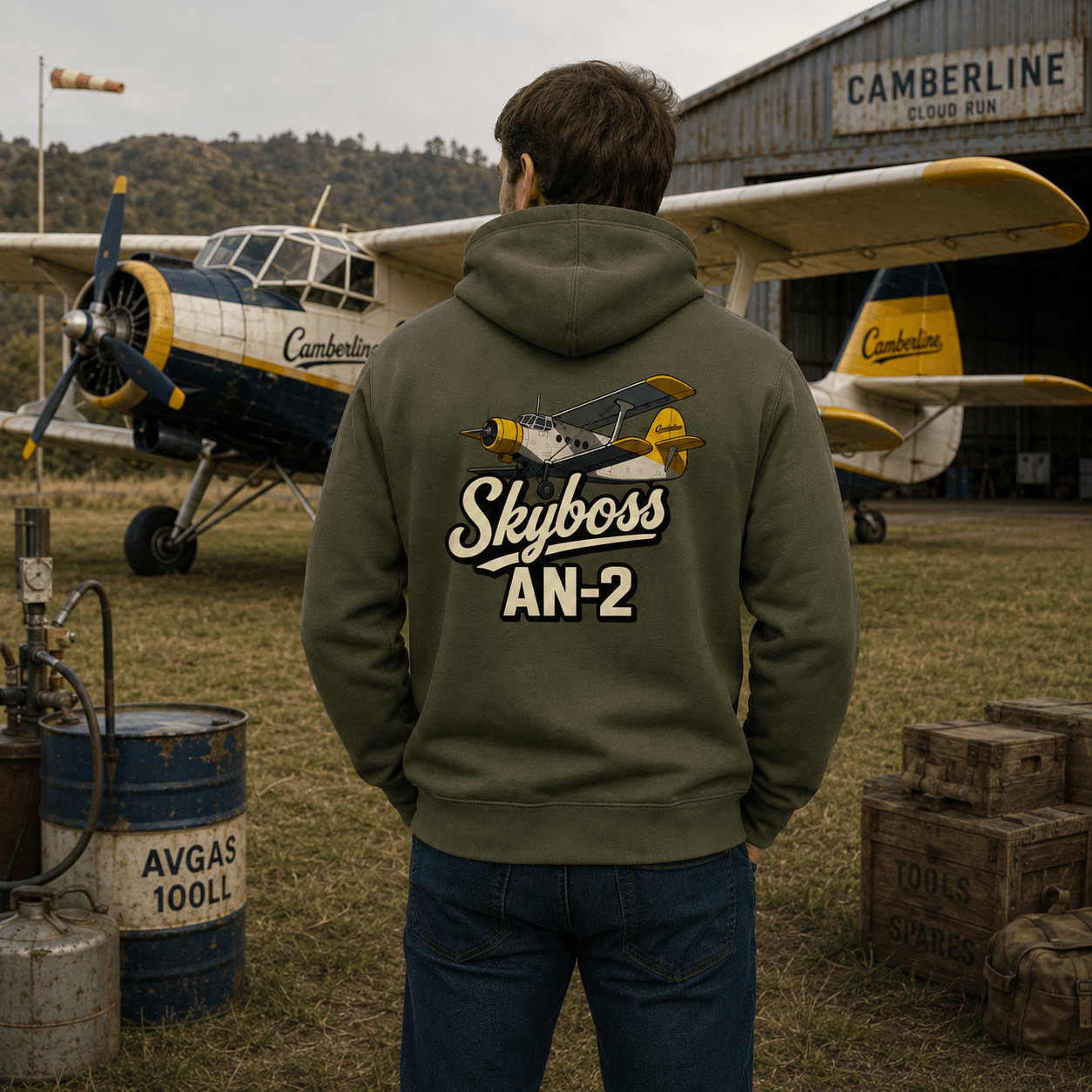 Person wearing a hoodie with 'Skyboss AN-2' design in front of an airplane.