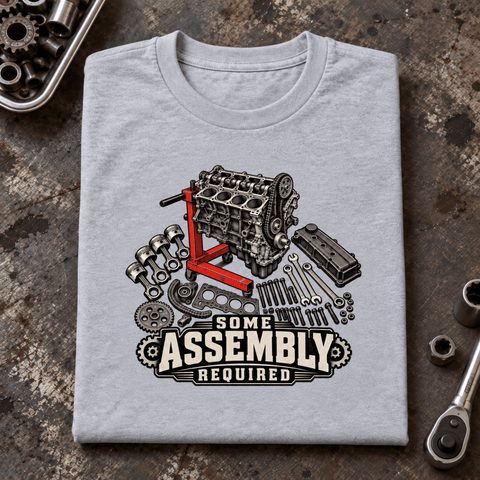 Camberline Engine Rebuild Mechanic T-Shirt in heather grey, folded front view on a workshop bench with full graphic visible
