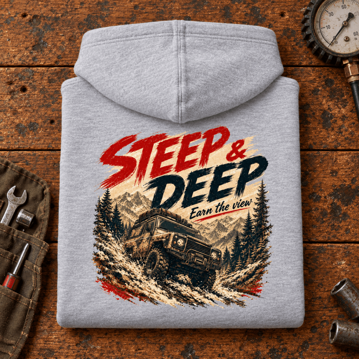 Folded heather grey Steep And Deep Hill Descent hoodie back on a workshop bench — car-hd-0092