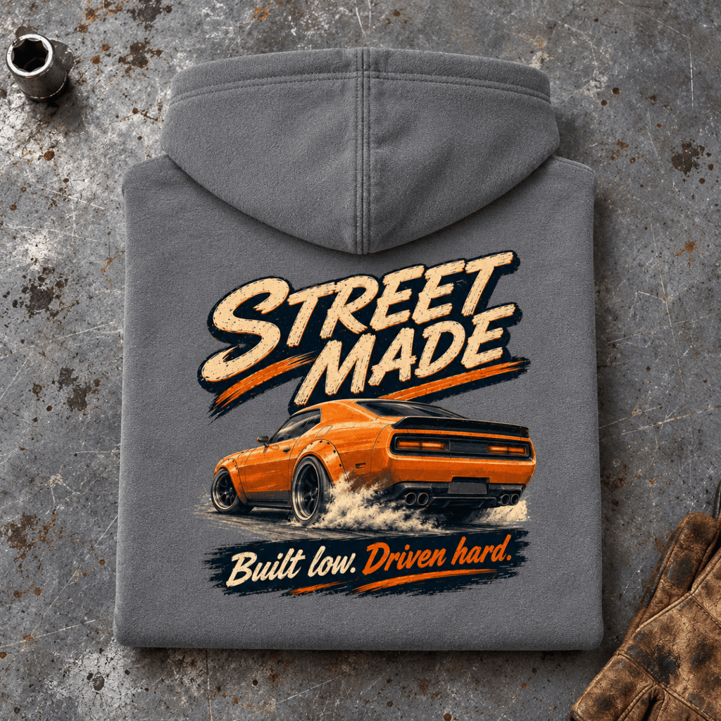 Folded charcoal Street Made Custom Build Charcoal hoodie back on a workshop bench — car-hd-0086