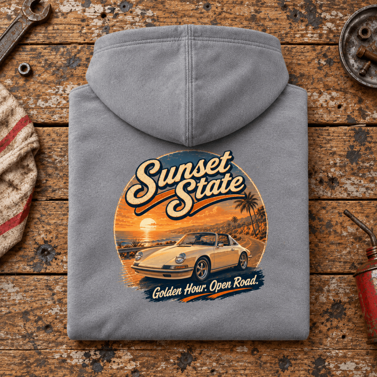 Classic Sports Car Graphic Hoodie – Sunset State Classic, folded back main hero on a worn automotive workbench – car-hd-0069