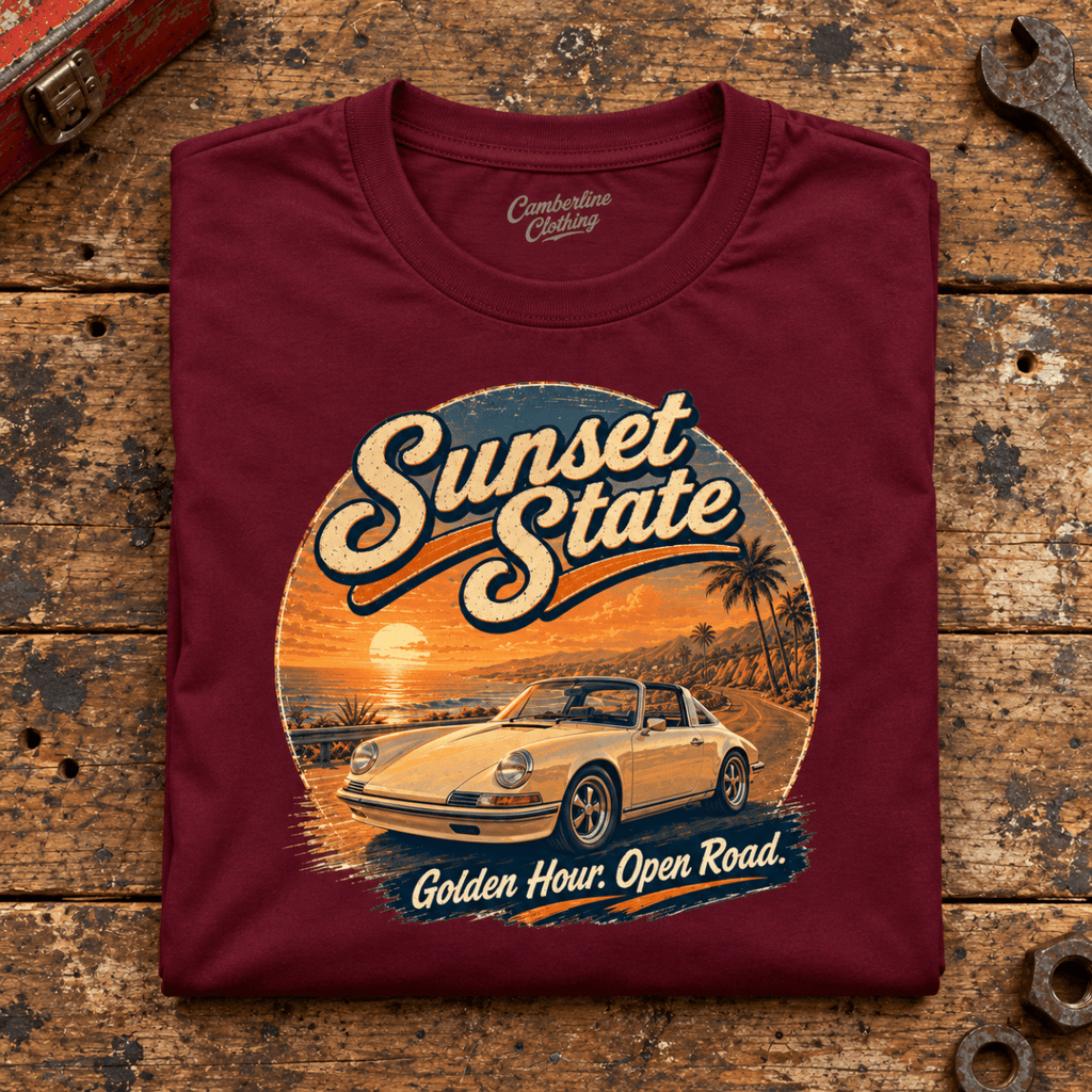 Classic Sports Car Graphic T-Shirt – Sunset State Classic, folded front main hero on a worn automotive workbench – car-ts-0069