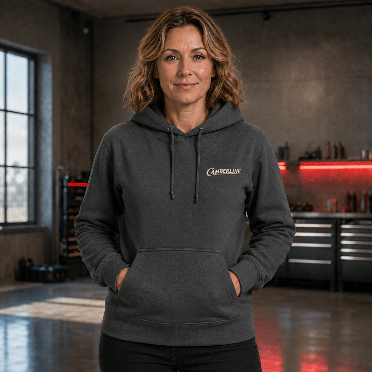 Front view of model wearing the dark grey Camberline hoodie with chest logo