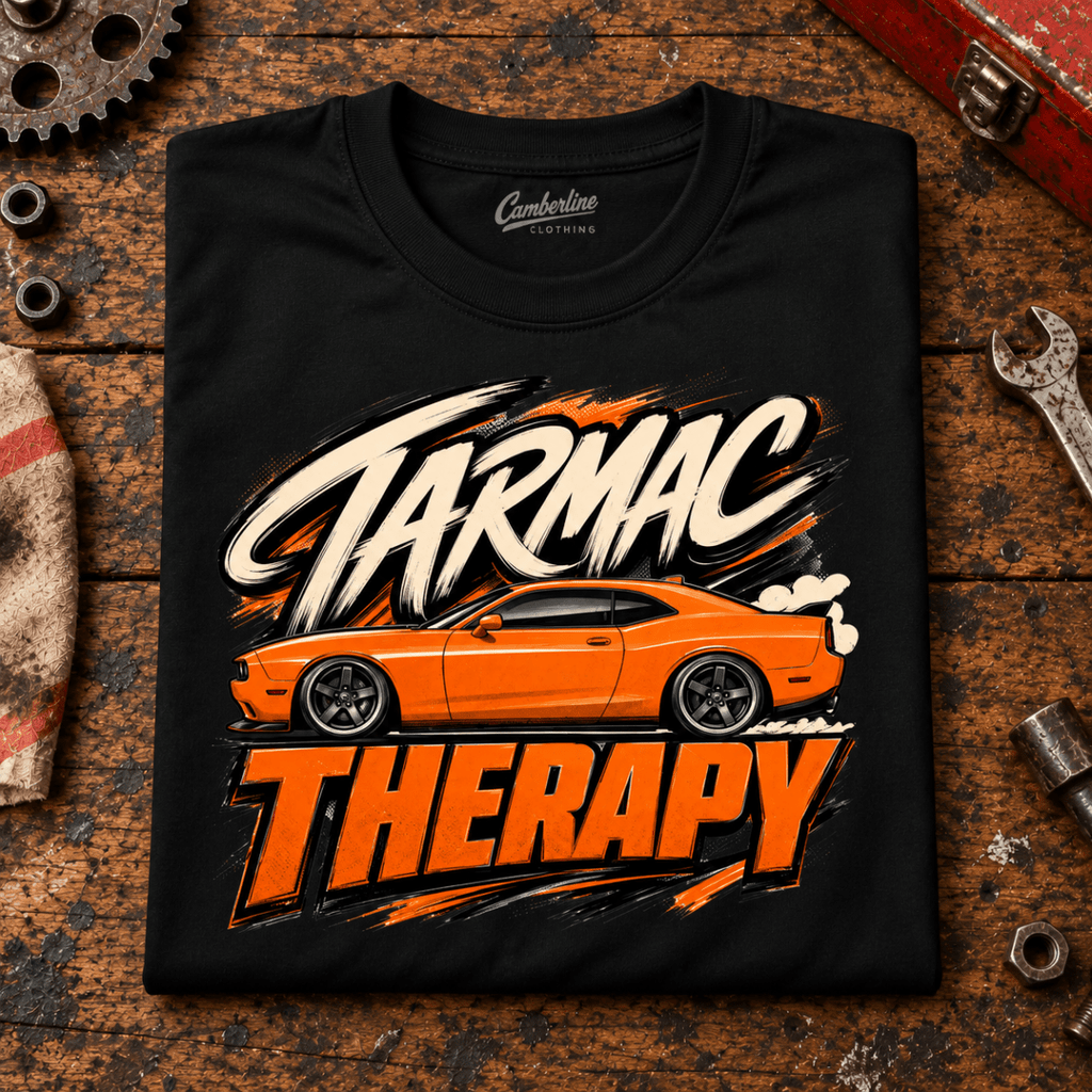 Muscle Car Graphic T-Shirt – Tarmac Therapy Car, folded front main hero on a worn automotive workbench – car-ts-0026