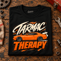 Muscle Car Graphic T-Shirt – Tarmac Therapy Car, folded front main hero on a worn automotive workbench – car-ts-0026