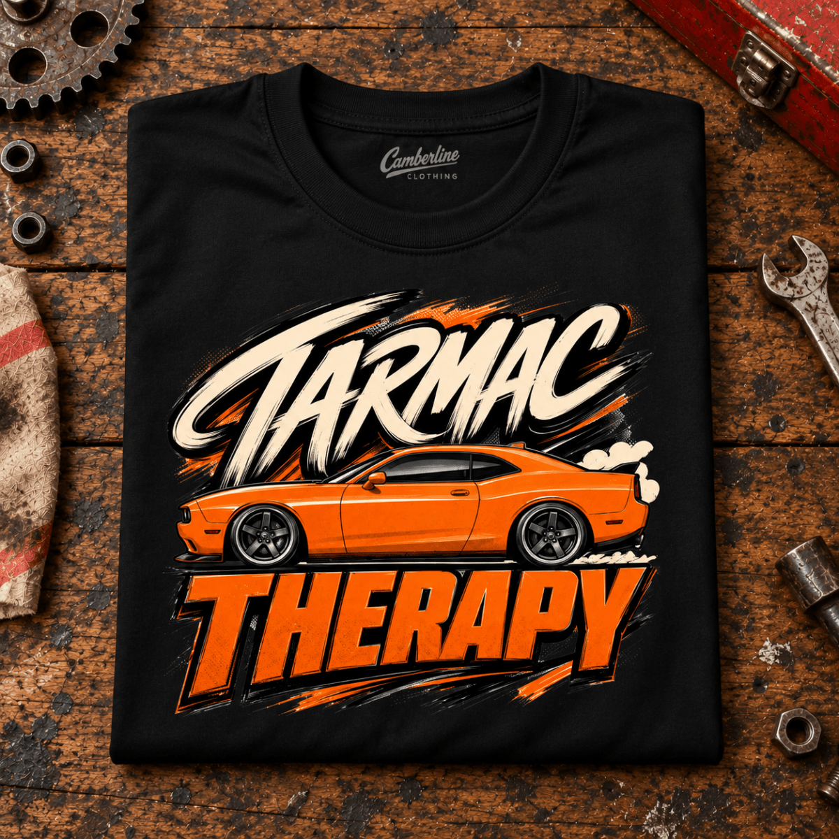 Muscle Car Graphic T-Shirt – Tarmac Therapy Car, folded front main hero on a worn automotive workbench – car-ts-0026