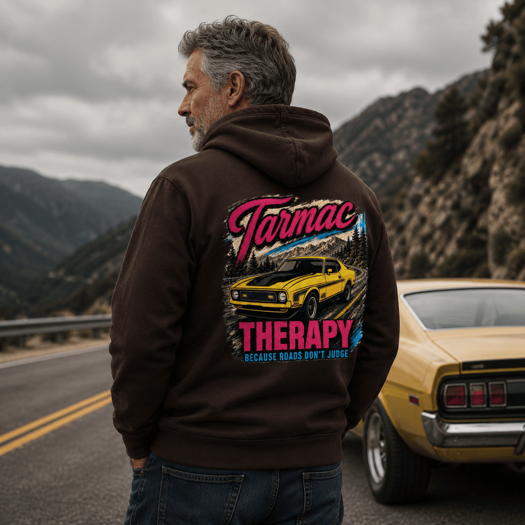 Model wearing the Camberline Cars Tarmac Therapy Muscle Car Hoodie – Hot Chocolate, showing the automotive graphic in a car culture setting