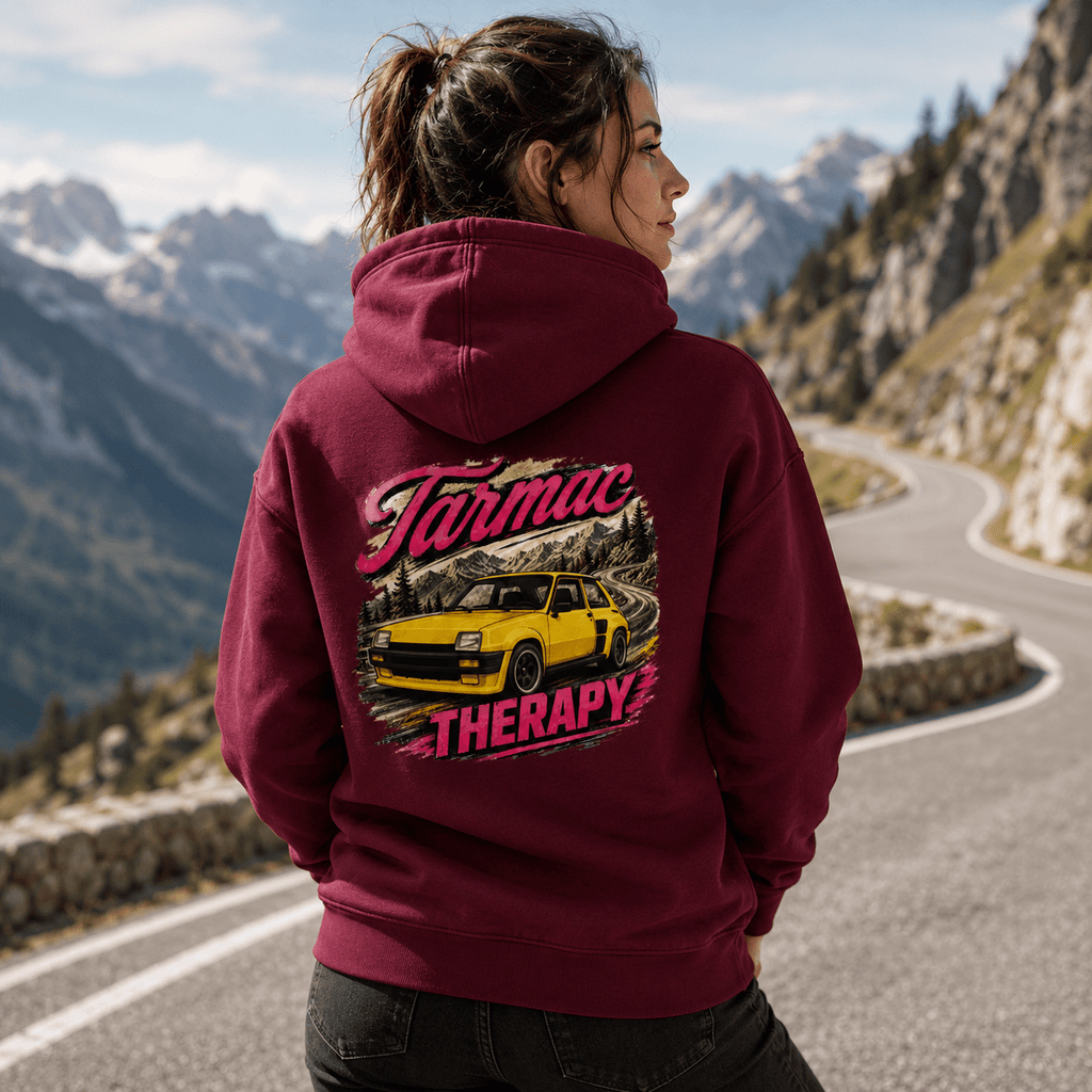 Model wearing the Camberline Cars Tarmac Therapy Yellow Hatch Hoodie – Burgundy, showing the automotive graphic in a car culture setting