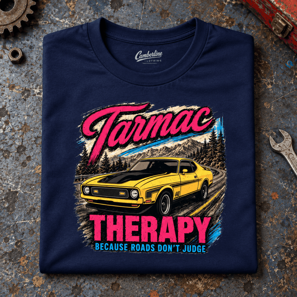 Muscle Car Graphic T-Shirt – Tarmac Therapy Yellow Car, folded front main hero on a worn automotive workbench – car-ts-0017