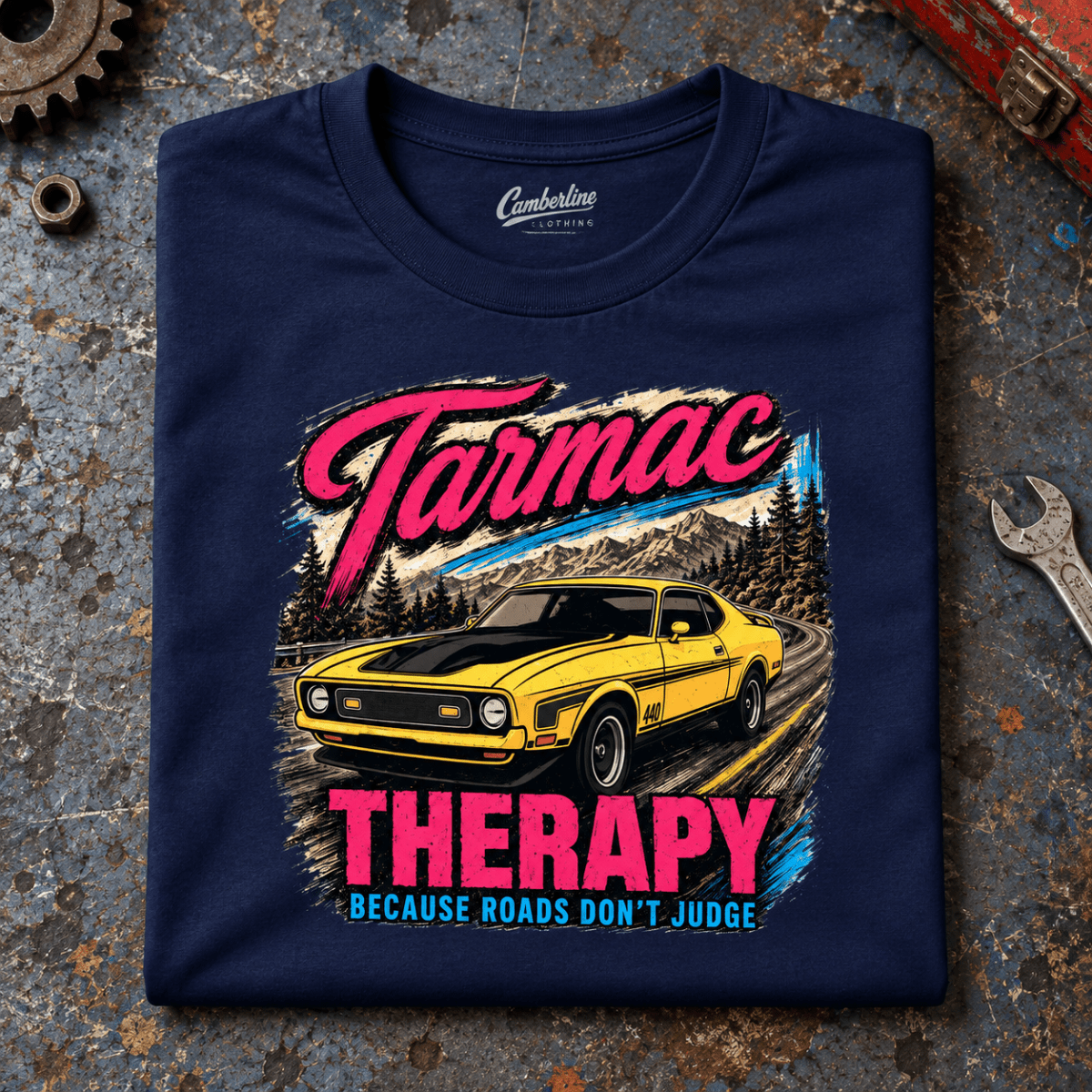 Muscle Car Graphic T-Shirt – Tarmac Therapy Yellow Car, folded front main hero on a worn automotive workbench – car-ts-0017