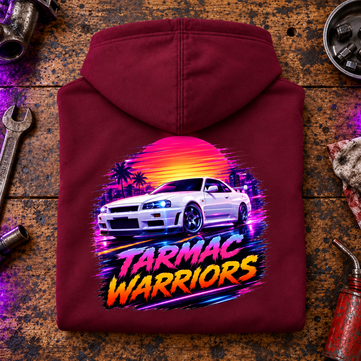 JDM Car Graphic Hoodie – Tarmac Warriors Retrowave Neon, folded back main hero on a worn automotive workbench – car-hd-0023