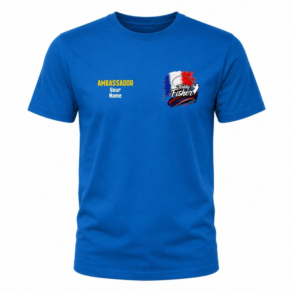 A royal blue short-sleeve crewneck t-shirt with custom printed graphics on the chest. The left chest features yellow and white placeholder text reading 'AMBASSADOR Beer Name', and the right chest features a 'Today's Fisherman' graphic with a French flag motif.