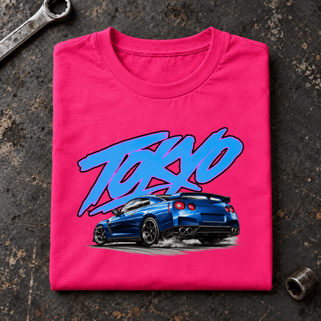 Camberline JDM Car Graphic T-Shirt in hot pink, folded front view on a workshop bench with the full graphic visible