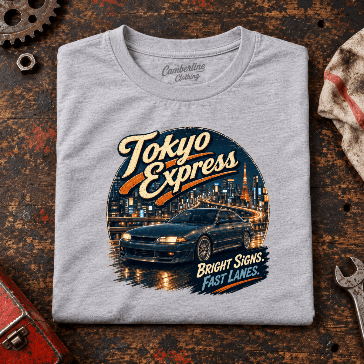 Tokyo Express Street Coupe JDM Urban Graphic T-Shirt — Sport Grey, folded front main hero on a worn automotive workbench – car-ts-0064