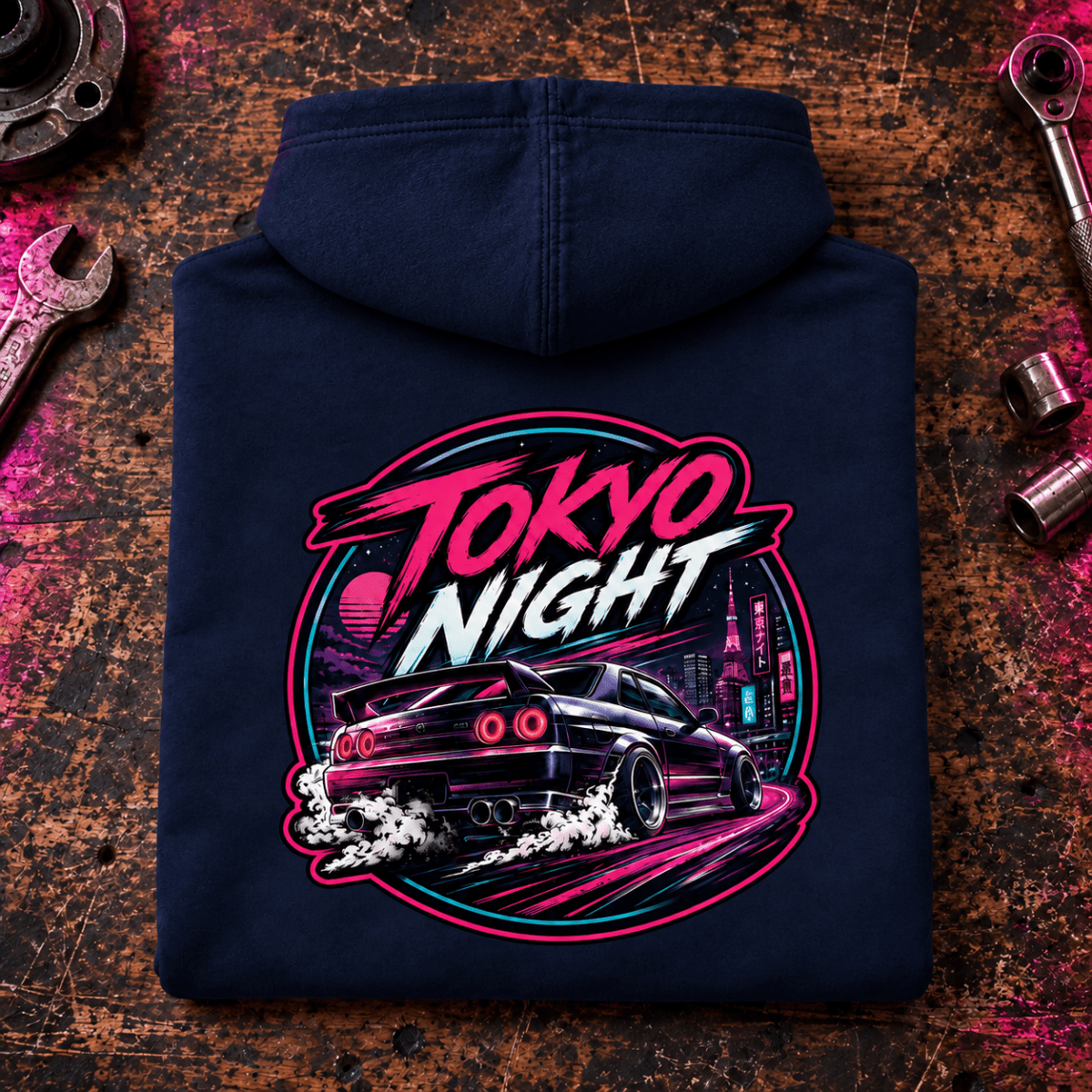 JDM Car Graphic Hoodie – Tokyo Night Drift Car, folded back main hero on a worn automotive workbench – car-hd-0034