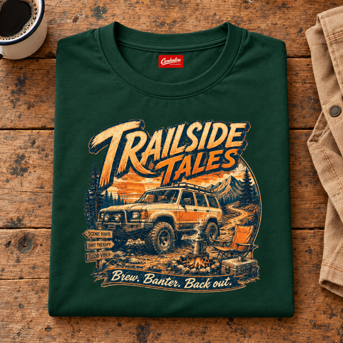 Folded forest green Trailside Tales Adventure T-shirt front on a workshop bench — car-ts-0006