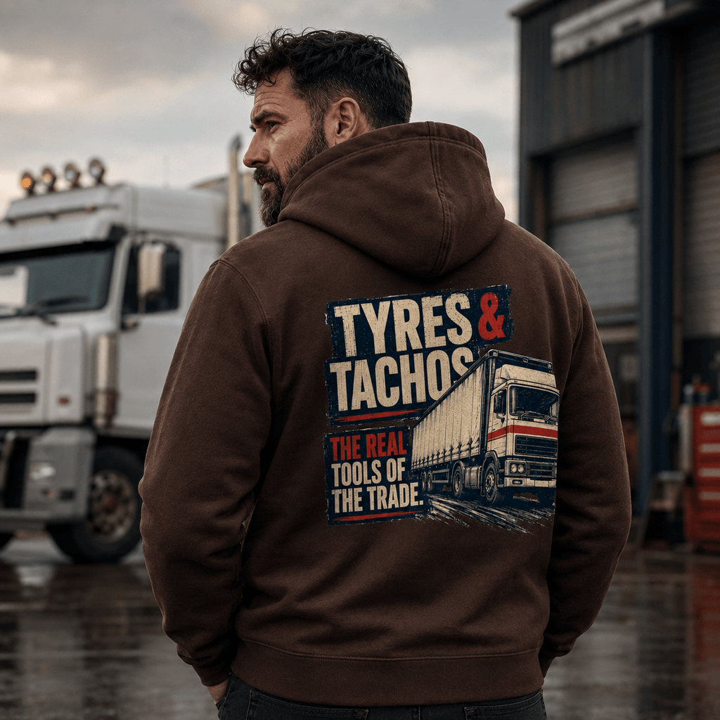 Man wearing a hoodie with 'Tyres & Tachos' design in front of a truck.