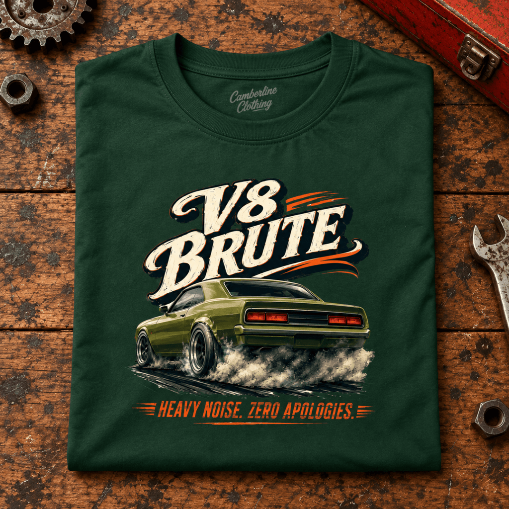 V8 Brute Muscle Car Raw Power Graphic T-Shirt — Forest Green, folded front main hero on a worn automotive workbench – car-ts-0072