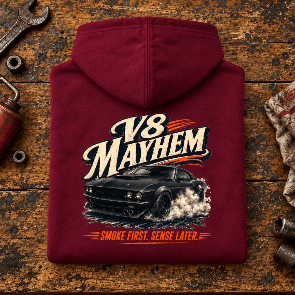 V8 Mayhem Muscle Fastback American Iron Graphic Hoodie — Burgundy, folded back main hero on a worn automotive workbench – car-hd-0070